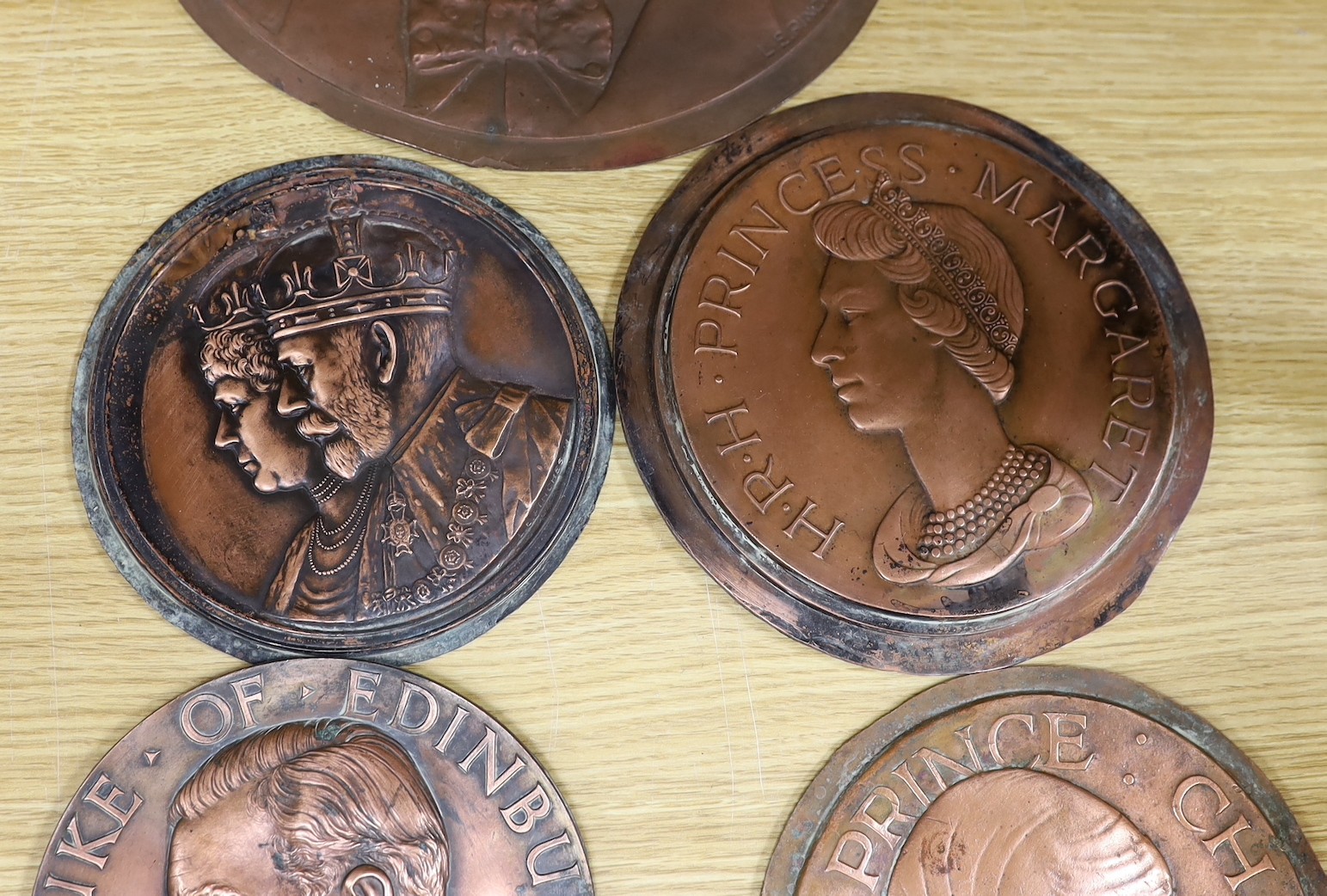 A group of six various cast copper or bronze medallion roundels. Largest 28cm diameter